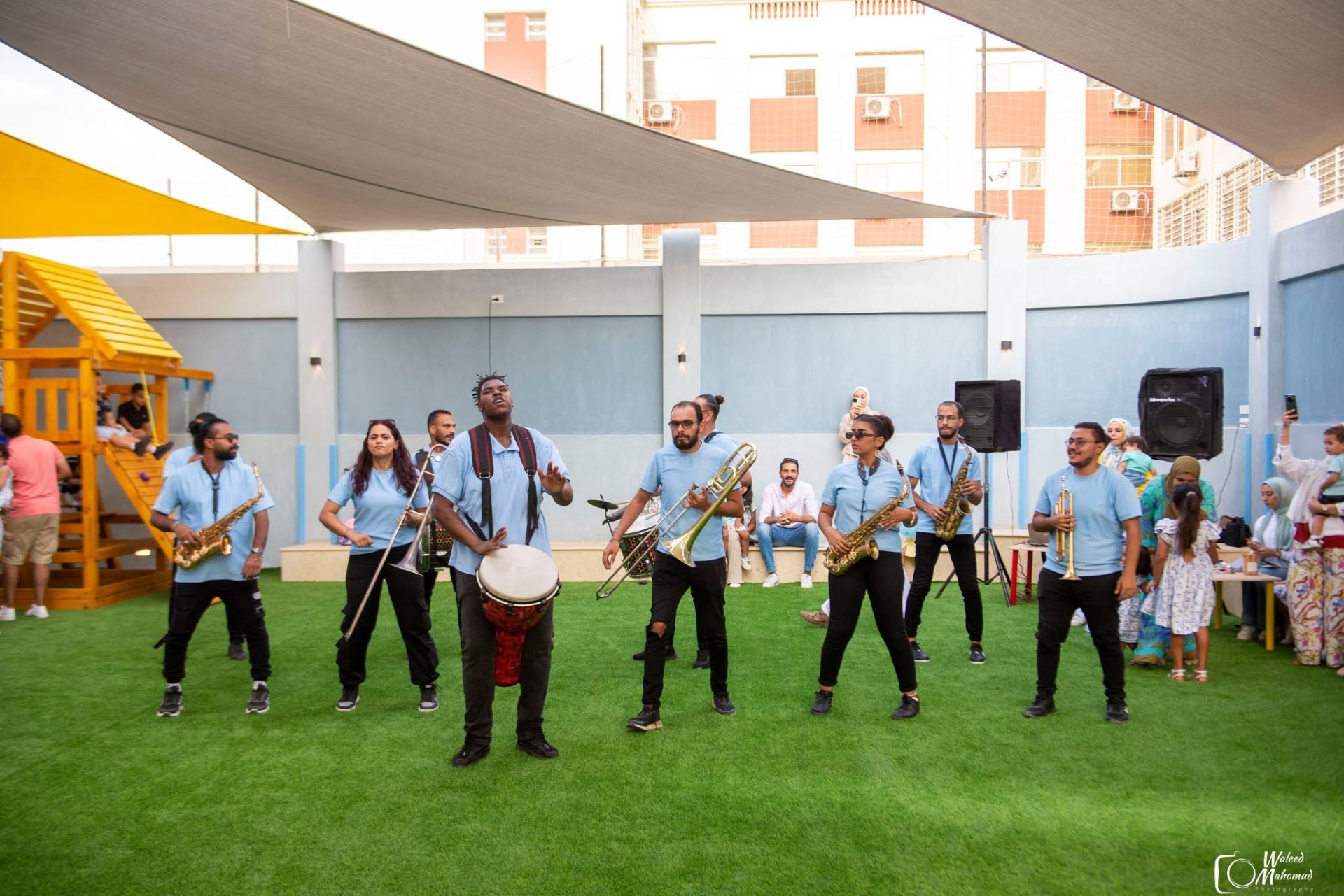 Live music band performing for kids in the outdoor play area